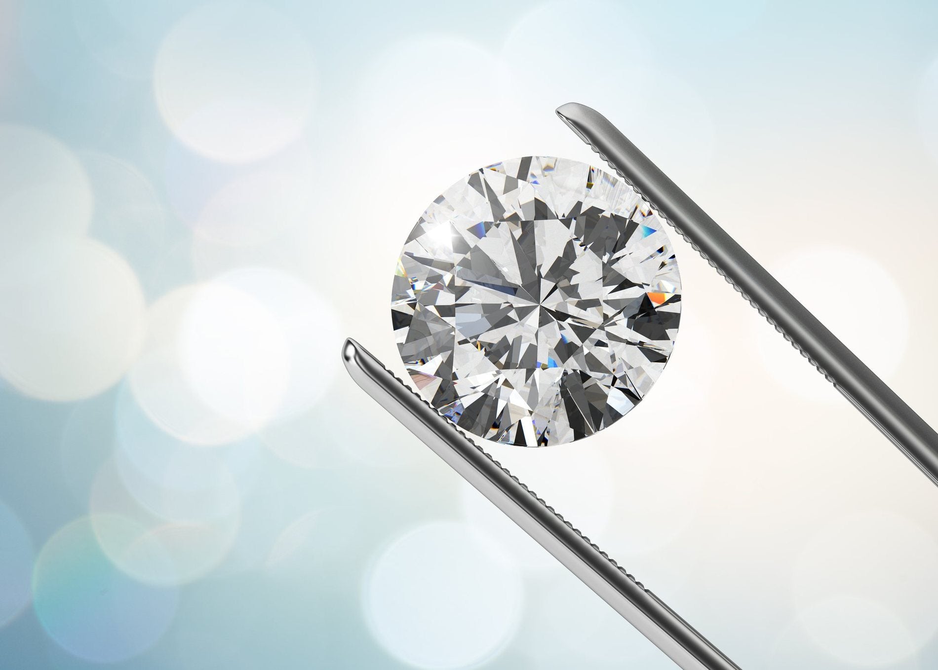 A jeweller presenting a brilliant-cut diamond held in tweezers